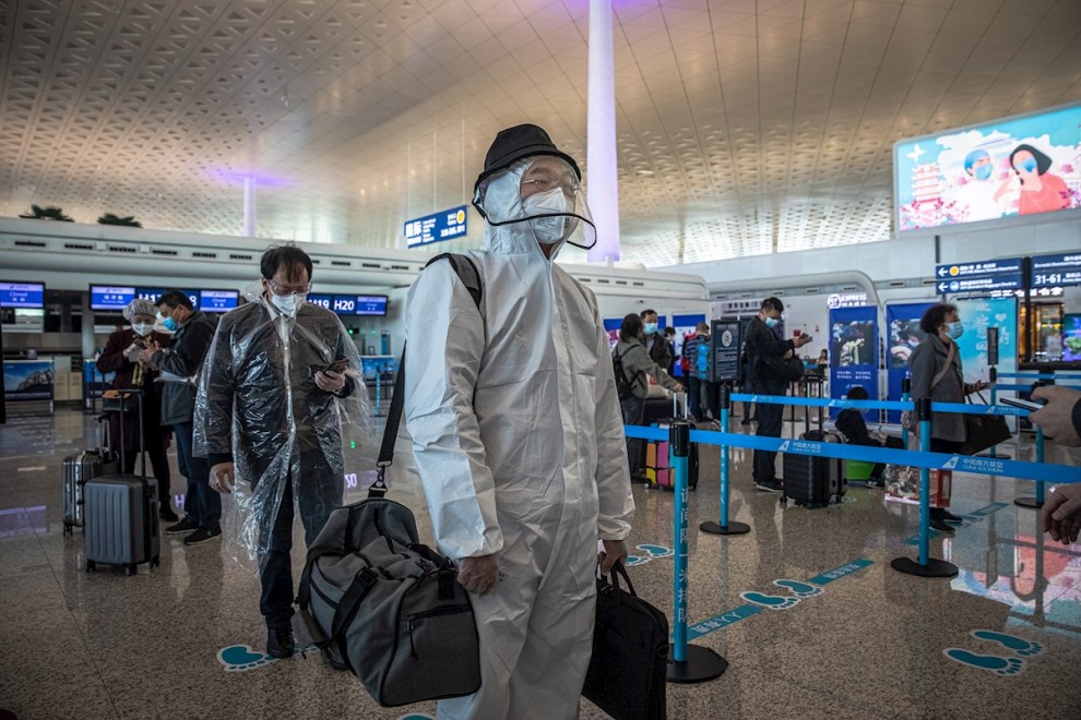 Los pasajeros con equipo de protección esperan en el aeropuerto internacional de Wuhan Tianhe después de que se levantó el bloqueo en Wuhan, China, el 8 de abril de 2020. EFE / ROMAN PILIPEY