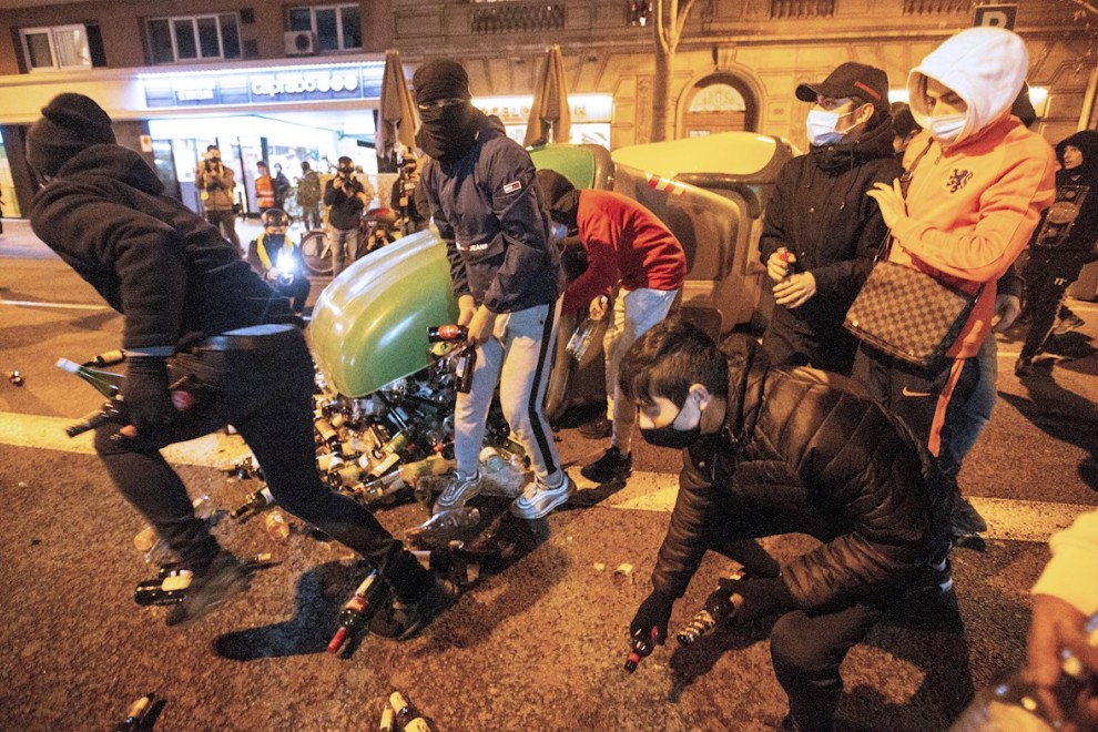 Manifestantes se disponen a lanzar botellas a la policía durante la protesta contra la detención y prisión del rapero Pablo Hasel,