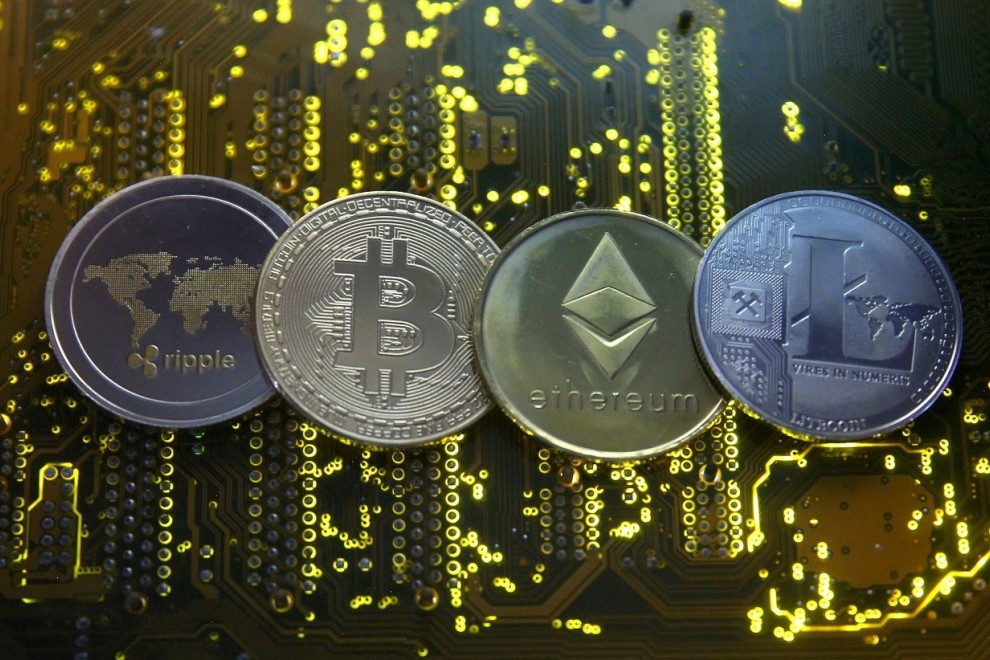 Representaciones de las monedas virtuales Ripple, bitcoin, etherum y Litecoin, sobre una placa base de un ordenador. REUTERS/Dado Ruvic/Ilustración
