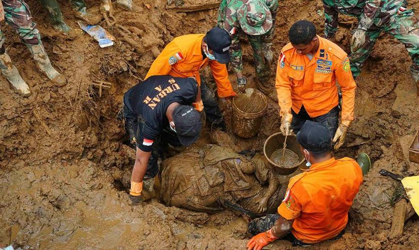 Soldados y miembros de los equipos de rescate recuperan los cadáveres de una madre y su hijo tras un deslizamiento de tierra en la aldea de Sampang en Banjarnegara. /ADHAD ZAKARIA (REUTERS)
