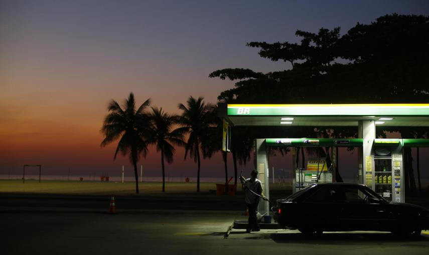 Un trabajador se prepara para cargar el depósito de un vehículo enun estación de servicio en la playa de Copacabana, en Rio de Janeiro (Brasil). REUTERS/Ricardo Moraes