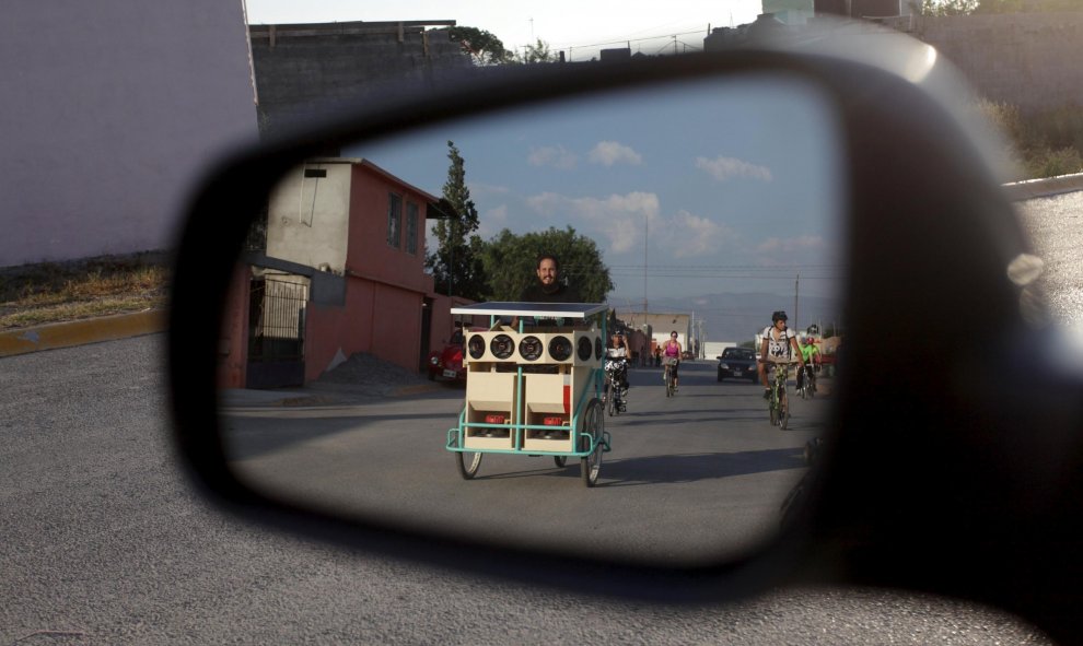 Un hombre con su bicicleta se refleja en un espejo lateral mientras se pedalea por las calles de Saltillo, México. REUTERS