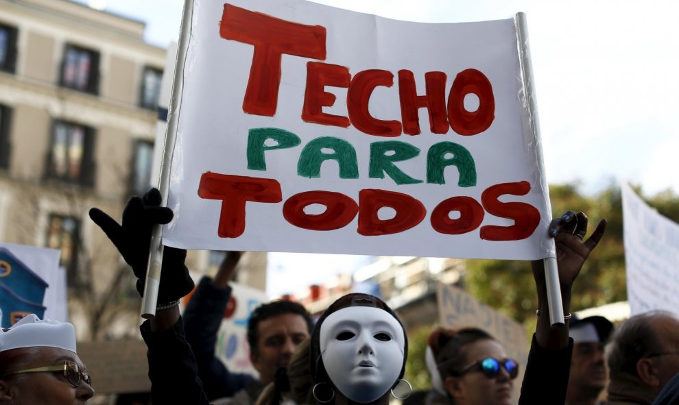 Un manifestante sujeta una pancarta donde se lee "TECHO PARA TODOS" en la protesta convocada por la plataforma "Nadie sin Hogar" por el derecho a la vivienda, en el centro de Madrid, España, 26 de noviembre de economía 2015. REUTERS / Paul Hanna