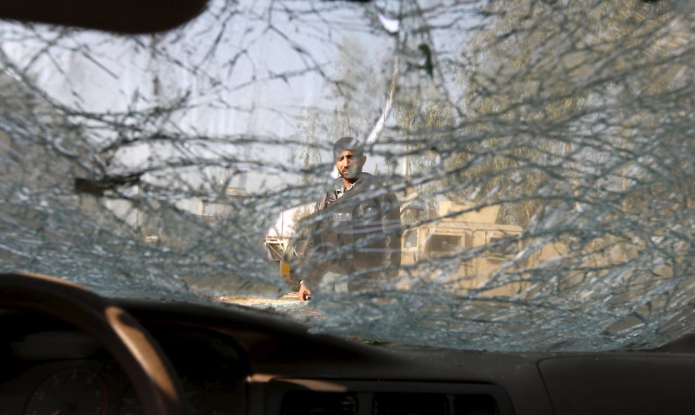 Un hombre afgano se ve desde el interior de un coche bomba tras explotar en la provincia de Nangarhar, Afghanistan. REUTERS/Parwiz