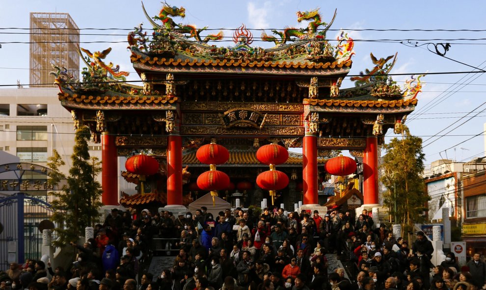 La gente espera sentada a baile de los leones en el Templo de Kanteibyo en Yokohama, al sur de Tokio, Japón. REUTERS/Thomas Peter