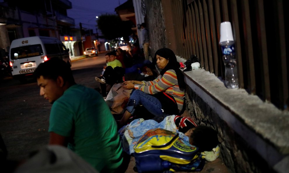 Las familias descansan a la intemperie a la espera de ingresar a la Comisión Mexicana de Asistencia para Refugiados (COMAR). / Reuters