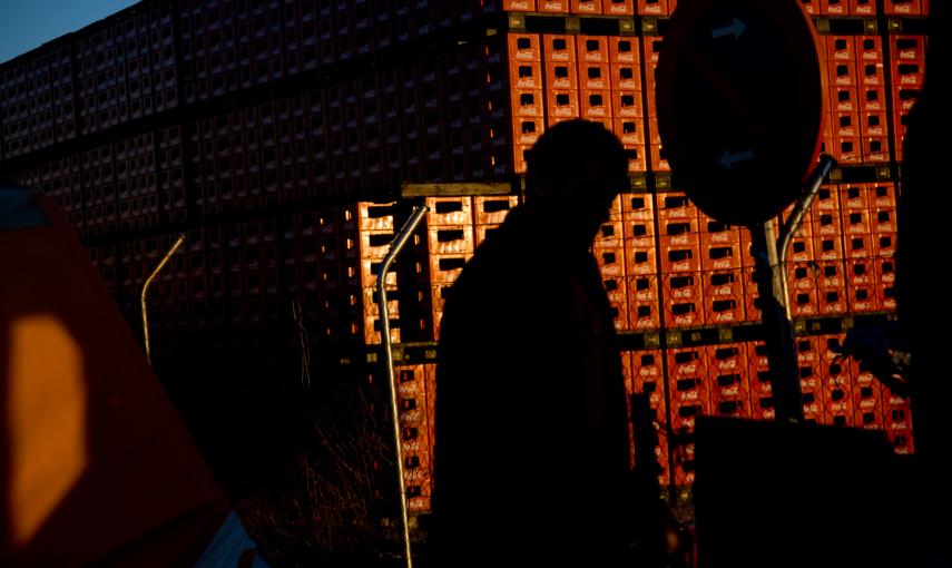 Un trabajador camina en el campamento donde llevan un año protestando a las puerta de la fábrica de Coca-Cola en Fuenlabrada contra su cierre. -JAIRO VARGAS