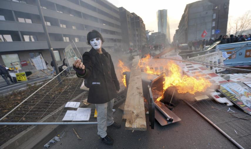 Manifestantes prenden mobiliario urbano durante una protesta ante la nueva sede del Banco Central Europeo (BCE) en Fráncfort (Alemania) hoy, miércoles 18 de marzo de 2015./ EFE-Andreas Arnold