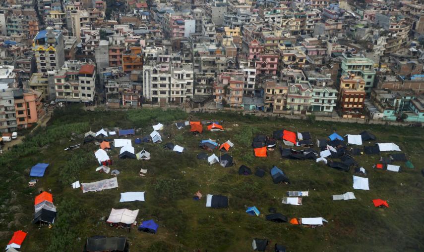 Los nepalís duermen en tiendas provisionales bajo lonas de plástico tras el terremoto del sábado, cerca del aeropuerto de Katmandú./ REUTERS-Wolfgang Rattay