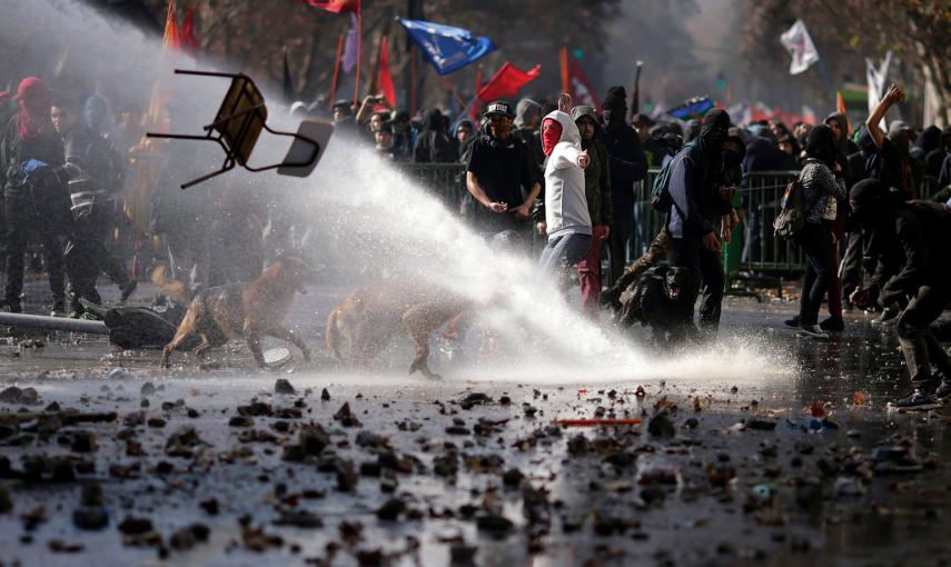 Los manifestantes lanzan una silla contra la policía durante una protesta para exigir cambios en el sistema educativo de Chile en Santiago.- UESLEI MARCELINO (REUTERS)