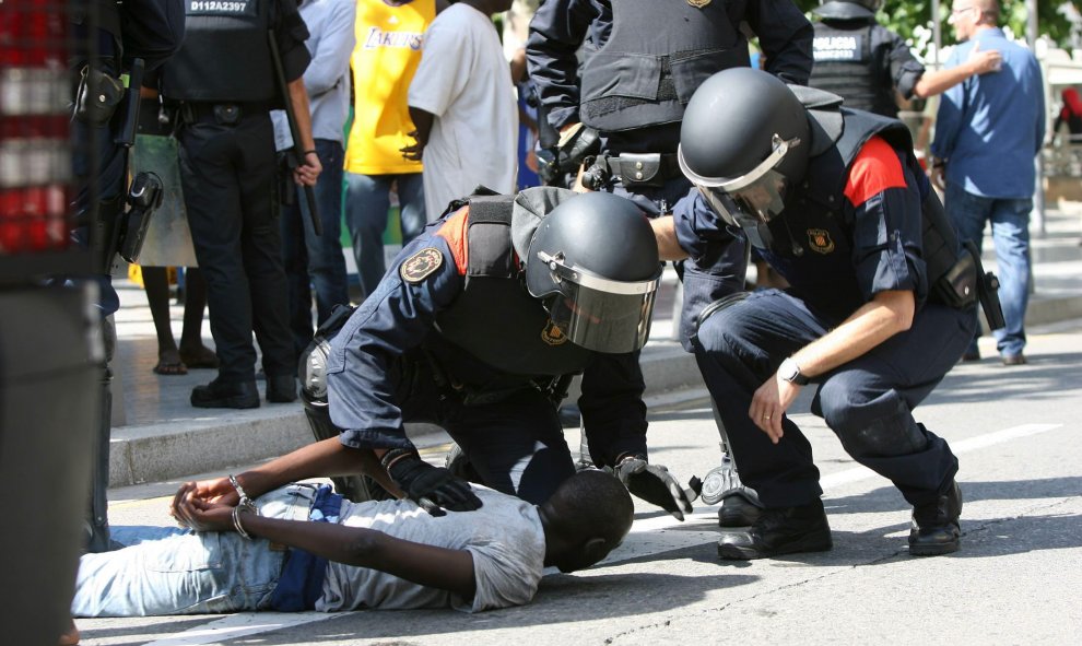 Miembros de los Mossos d'Esquadra retienen a un participante en los disturbios que han tenido lugar hoy en Salou. EFE/Jaume Sellart