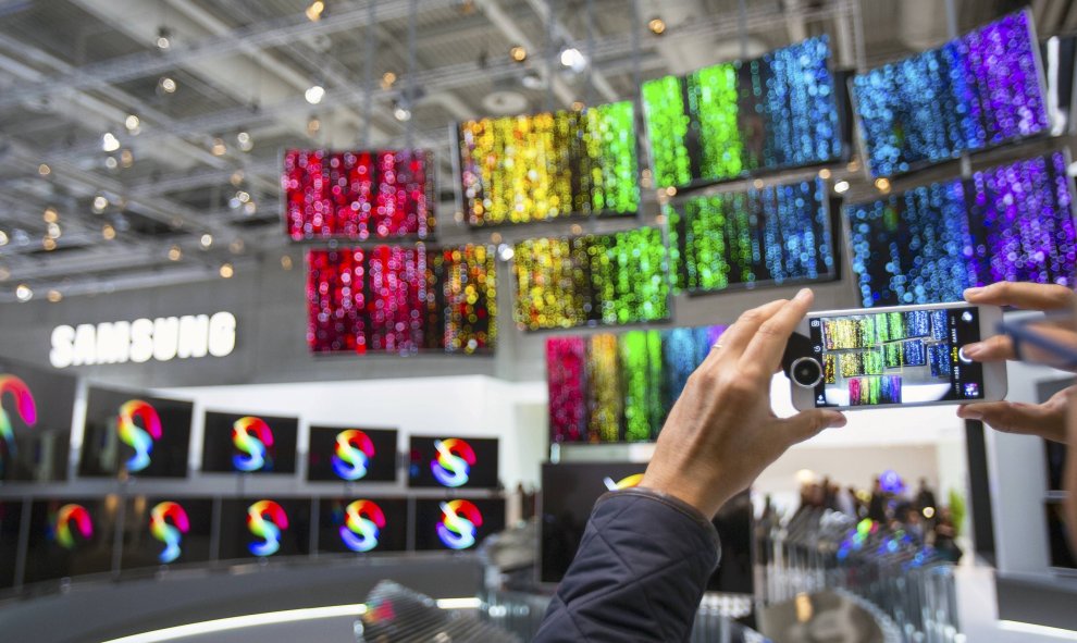 Un hombre hace una foto a las pantallas curvadas de Samsung en la feria de productos electrónicos de consumo en Berlín, Alemania, 3 de septiembre de 2015. REUTERS/Hannibal Hanschke