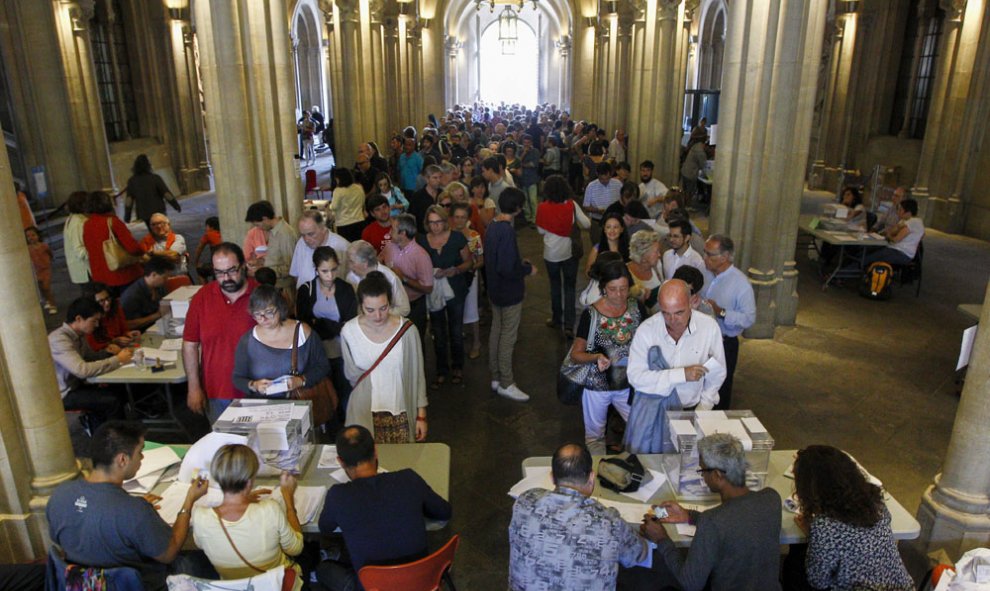 Colas de ciudadanos esperan su turno para votar en un colegio electoral de Barcelona. EFE/Quique García