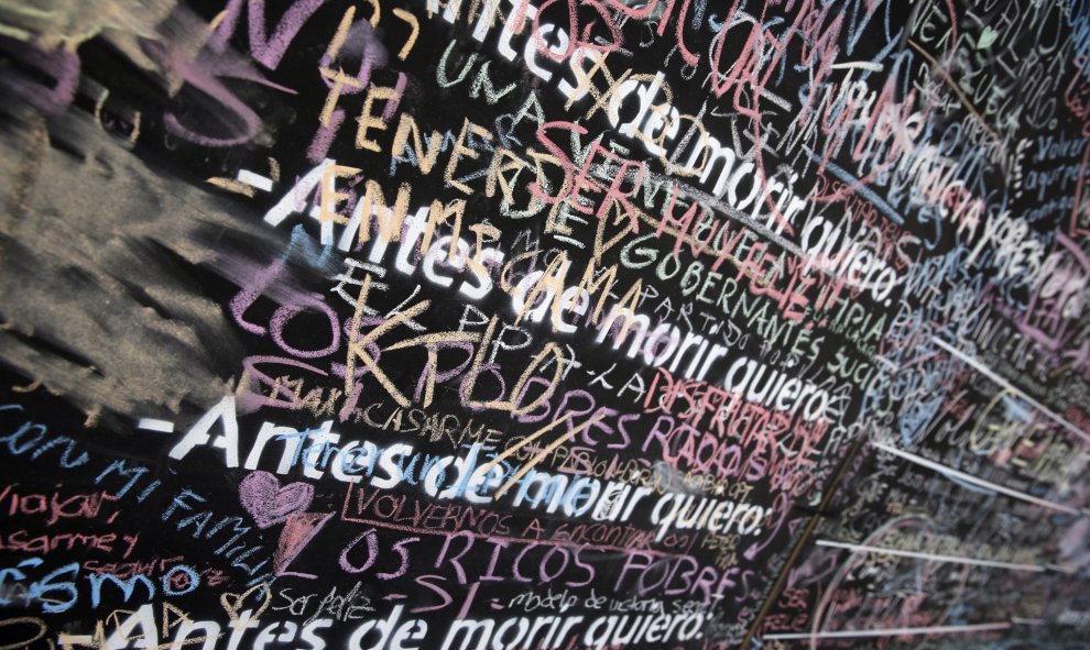 Pizarra mural instalada en la Puerta del Sol de Madrid, que forma parte de una iniciativa de la ONG "Alianza por la Solidaridad" en la que se invita a los ciudadanos a completar la frase "Antes de morir quiero..." para hacer reflexionar a la ciudadanía so