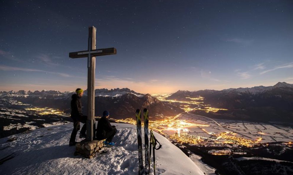 Dos esquiadores disfrutan de las vistas desde el pico Garmil, a 2.003 metros sobre el nivel del mar. Vilters-Wangs, Suiza. EFE/Gian Ehrenzeller