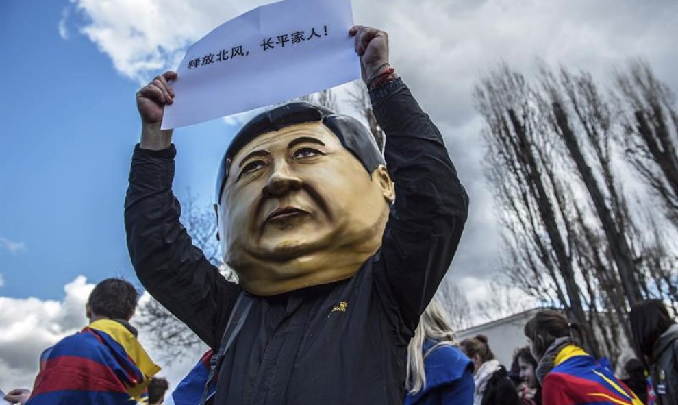 Un manifestante que lleva puesta una cabeza con la imagen del presidente chino, Xi Jinping, participa en una protesta por la visita del mandatario en Praga. EFE/Filip Singer