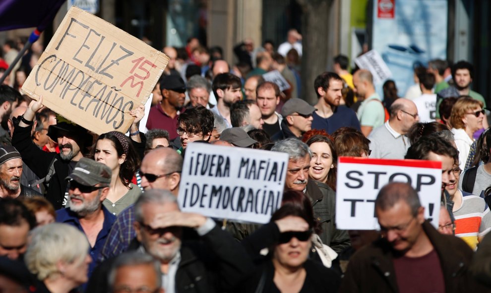 A man holds a placard reading "happy birthday 15M" during a march to mark the 5th anniversary of the "indignados" movement in Madrid, Spain, May 15, 2016. REUTERS/Sergio Perez