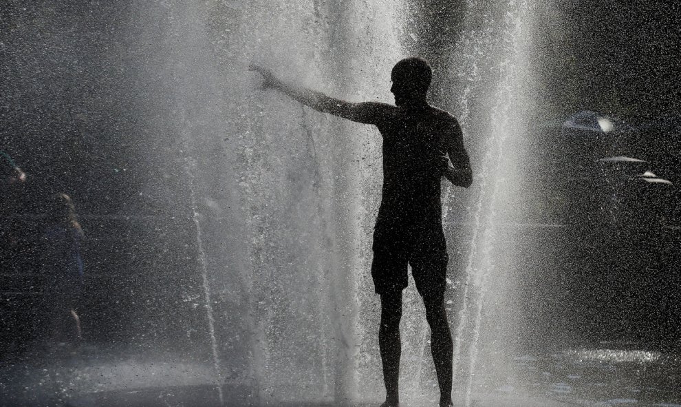 Un hombre se refresca en una fuente en Nueva York. REUTERS/Brendan McDermid