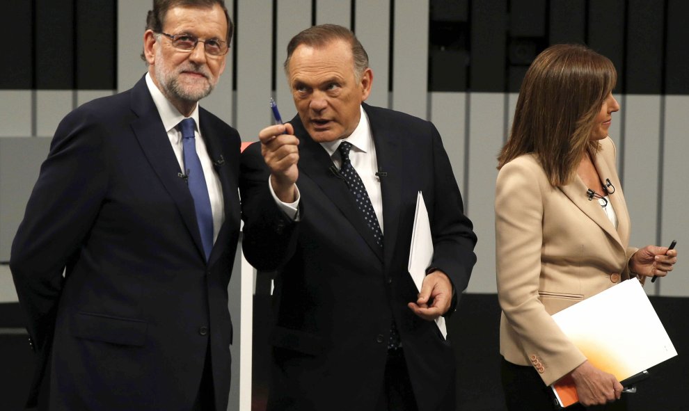 El presidente del Gobierno en funciones y del PP, Mariano Rajoy (i), atiende a uno de los moderadores del programa, Pedro Piqueras (c), junto a otra de las presentadoras Ana Blanco (d), en el plató momentos antes de iniciar el único debate a cuatro de la