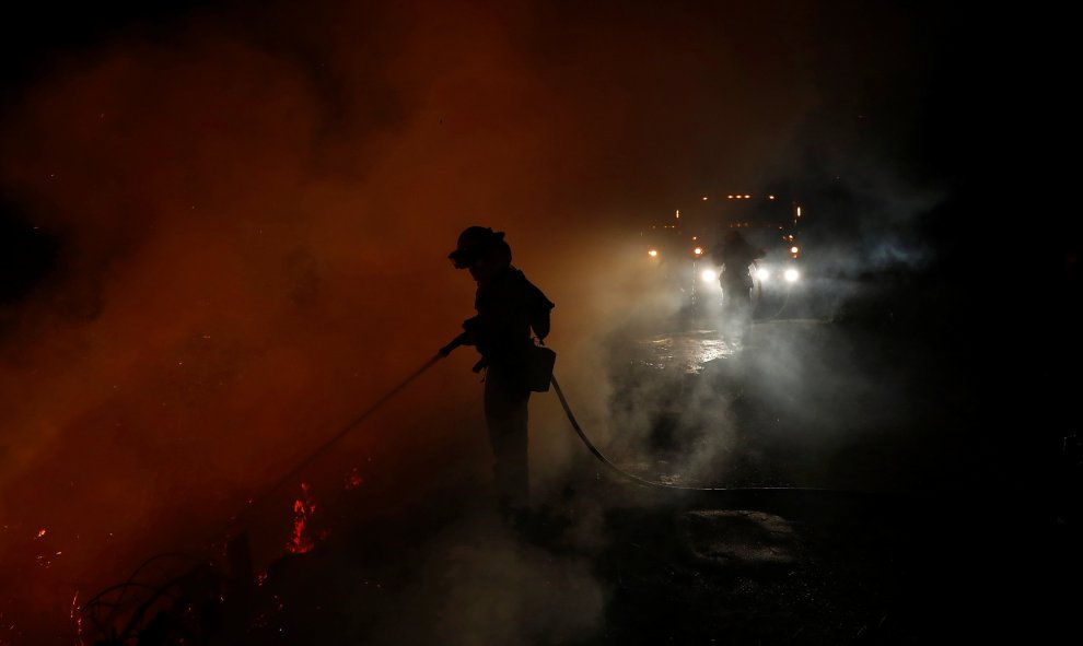 Los bomberos luchan contra el fuego de Loma, cerca de Santa Cruz, California. REUTERS/Stephen Lam