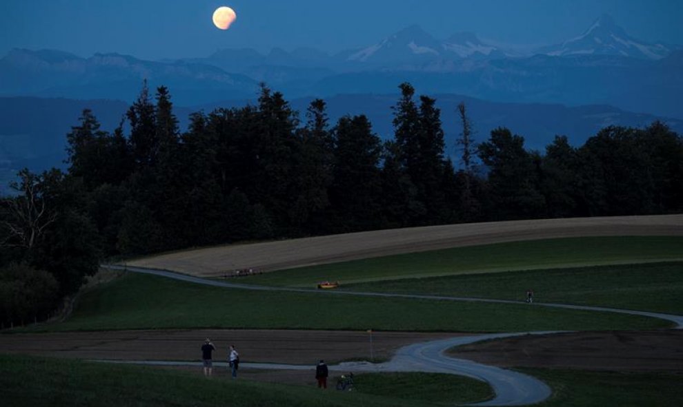 Vista de la luna llena durante un eclipse lunar parcial, este lunes 7 de agosto, en los Alpes berneses, en Berna (Suiza). EFE / Anthony Anex