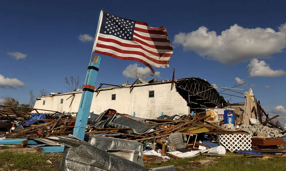 Una bandera de los Estados Unidos ondea frente a un edificio dañado por el huracán Michael en la ciudad de Panamá, Florida, el 11 de octubre de 2018. REUTERS / Jonathan Bachman