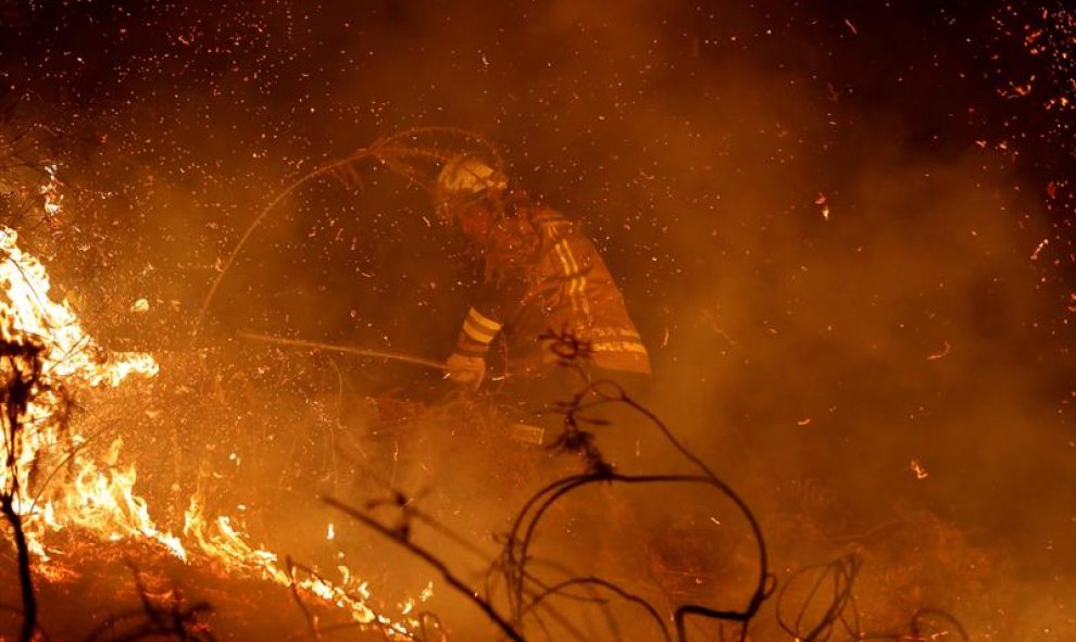 LABARES (ASTURIAS), 03/03/2019.- Los bomberos intentan sofocar el incendio que se ha producido hoy en los alrededores de Labares. Un total de 77 incendios se encuentran activos en Asturias, contra los que luchan unas 200 personas, a las que se sumarán mañ