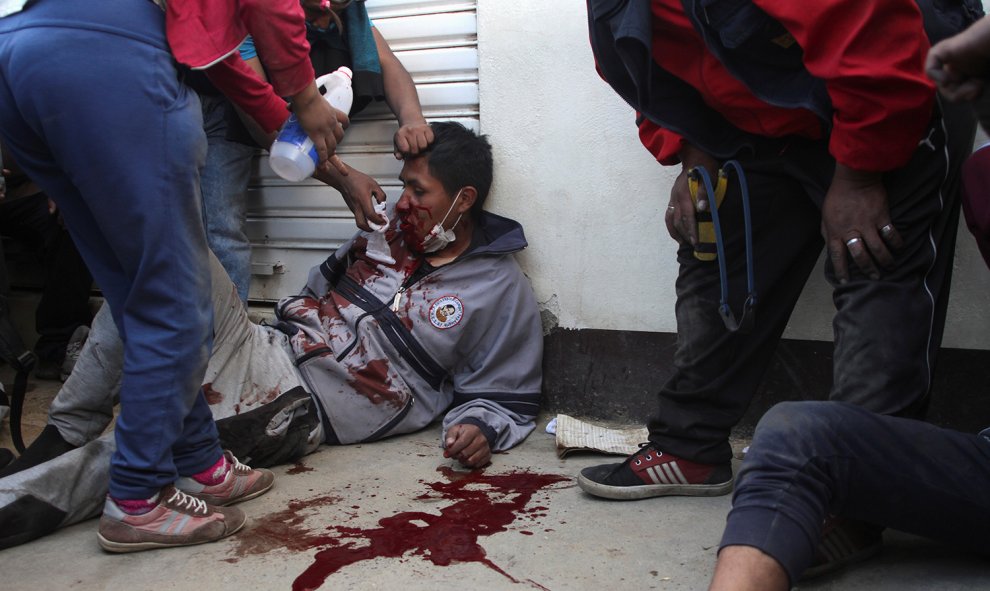 Los manifestantes ayudan a un hombre herido durante los enfrentamientos cerca de la planta de gasolina en Senkata, en las afueras de El Alto, La Paz, Bolivia, el 19 de noviembre de 2019. REUTERS / Pablo Aneli