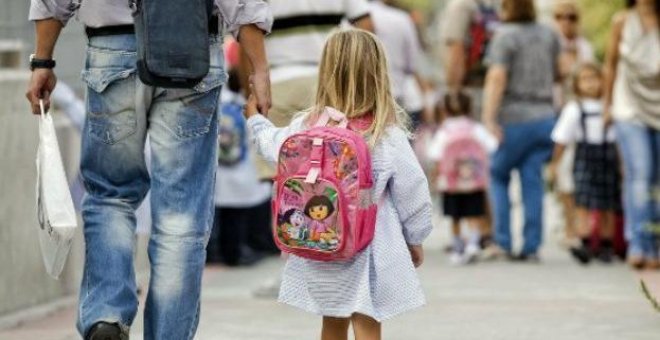 Un padre lleva de la mano a su hija en una calle de Madrid./EFE