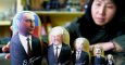Una tendera china enseña una colección de muñecas matrioskas con las caras de Putin, Yeltsin, Gorbachov, Stalin y Lenin.- AFP