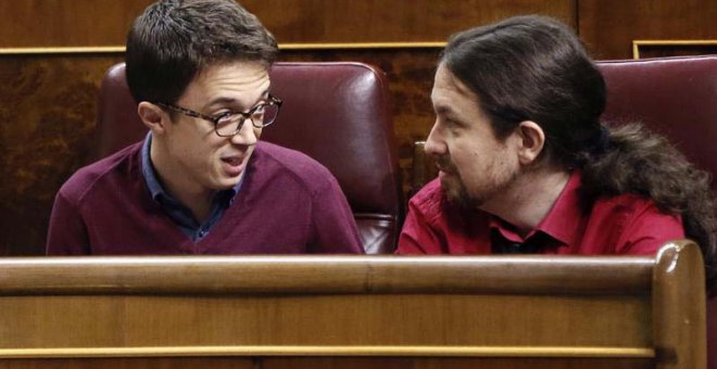 El líder de Podemos, Pablo Iglesias (d), conversa con el portavoz parlamentario de esta formación, Íñigo Errejón, en el hemiciclo del Congreso. | FERNANDO ALVARADO (EFE)