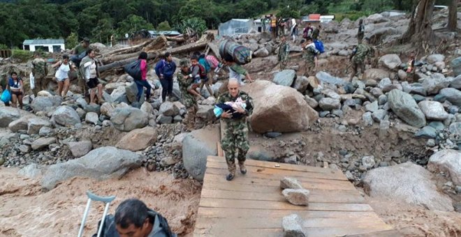 Fotografía cedida por el Ejército de Colombia de sus integrantes ayudando a pobladores por los estragos ocasionados por la avalancha de Mocoa (Colombia), con 254 muertos y 202 heridos.