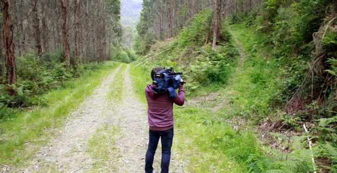 Un cámara de televisión toma imágenes de la zona donde apareció el cuerpo sin vida del niño de once años al que presuntamente mató su padre en este monte del concello coruñés de Oza-Cesuras.EFE/Cabalar
