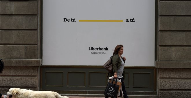 Una mujer pasa frente a la sede de Liberbank en Oviedo. REUTERS