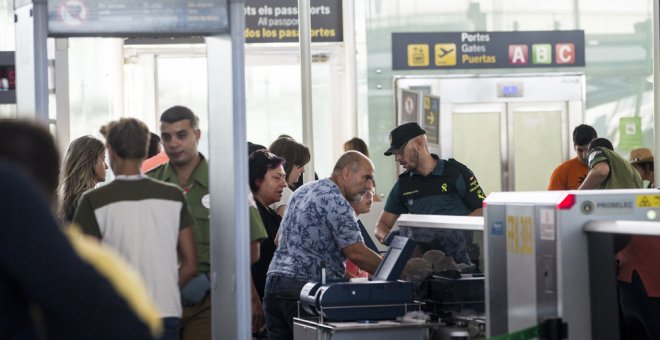 Efectivos de la Guardia Civil trabajan en los accesos a las puertas de embarque del aeropuerto de Barcelona-El Prat . EFE/Quique García