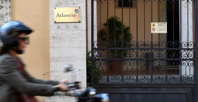 Un motorista pasa junto a la entrada de la sede de la empresa italiana de concesión de infraestructuras Atlantia en Roma. AFP/Filippo Monforte