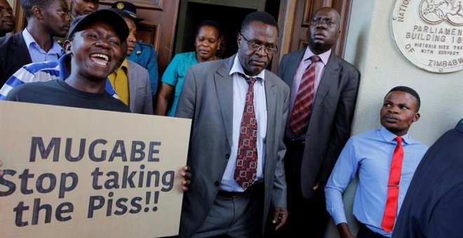 Manifestantes protestan mientras los diputados asisten a la sesión parlamentaria en Harare. | KIM LUDBROOK (EFE)