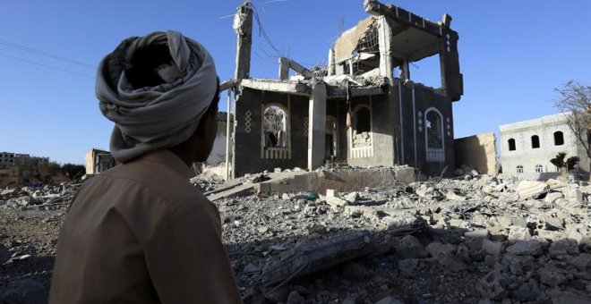 Un yemení se sienta frente a un edificio presuntamente destruido por recientes ataques aéreos, en el tercer aniversario de la campaña militar encabezada por Arabia Saudí en Yemen, en Saná, Yemen. EFE / EPA / YAHYA ARHAB