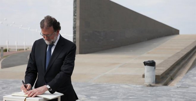 El presidente del Gobierno, Mariano Rajoy, firma en el libro de honor a las victimas de la dictadura argentina durante su visita al Parque de la Memoria. / EFE