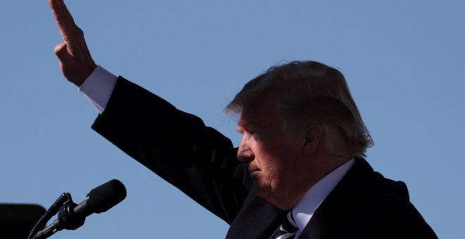 El presidente de EEUU, Donald Trump, levanta el brazo para saludar en un acto en el aeropuerto de Nevada. REUTERS/Jonathan Ernst