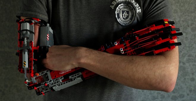 David Aguliar poses with his prosthetic arm built with Lego pieces during an interview with Reuters in Sant Cugat del Valles, near Barcelona, Spain, February 4, 2019. Picture taken on February 4, 2019. REUTERS/Albert Gea