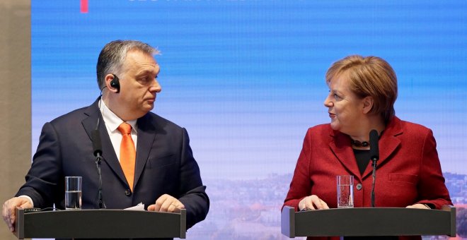 German Chancellor Angela Merkel speaks to Hungarian Prime Minister Viktor Orban during a news conference after the summit of the Prime Ministers of the Visegrad Group and Germany in Bratislava