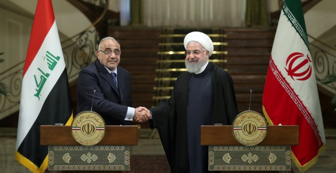 Iranian President Hassan Rouhani shake hands with Iraq's Prime Minister Adel Abdul Mahdi during a news conference in Tehran