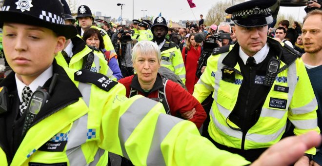 16/04/2019 - Agentes de policía se llevan a una activista para desbloquear del puente de Waterloo en el segundo día de protestas | AFP/ Daniel Leal-Olivas