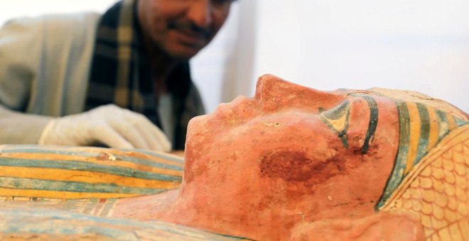 Un trabajador egipcio inspeccionando un sarcófago. Reuters