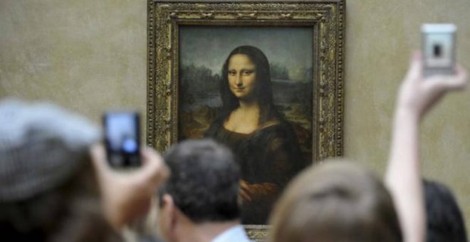 Un grupo de turistas fotografía 'La Gioconda' en el Museo del Louvre, en París.- EFE