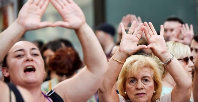 Dos mujeres asisten a la concentración convocada por la asociación feminista Gafas Moradas este lunes en la Plaza Moyúa de Bilbao contra "los feminicidios y las agresiones machistas". EFE