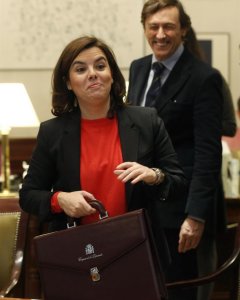 La vicepresidenta del Gobierno, Soraya Sáenz de Santamaría, acompañada por el portavoz del PP en el Congreso, Rafael Hernando (d), recoge su cartera tras formalizar el acta como diputada en el Congreso. EFE/Kiko Huesca