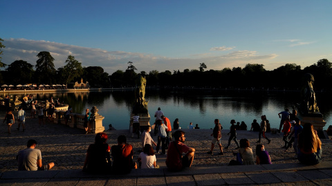 Personas paseando y tomando el sol junto al lago del Parque del Retiro, en Madrid, el primer día de su reapertura tras el cierre durante el estado de alarma por la pandemia del coronavirus. REUTERS/Juan Medina Personas paseando y tomando el sol junto al lago del Parque del Retiro, en Madrid, el primer día de su reapertura tras el cierre durante el estado de alarma por la pandemia del coronavirus. REUTERS/Juan Medina
