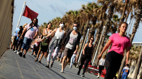 Personas paseando por la playa de la Barcelonetta, en el primer día que se permite paseos y actividades deportivas en la desescalada del estado de alarma por la pandemia de coronavirus. REUTERS/Nacho Doce Personas paseando por la playa de la Barcelonetta, en el primer día que se permite paseos y actividades deportivas en la desescalada del estado de alarma por la pandemia de coronavirus. REUTERS/Nacho Doce